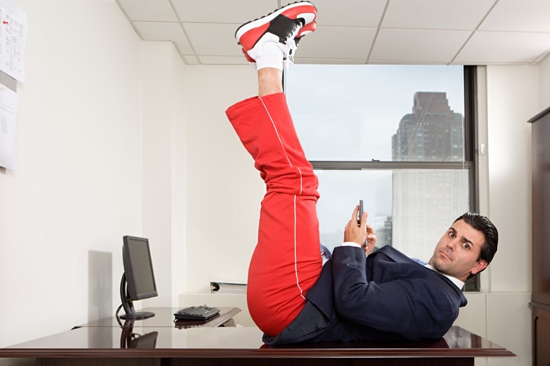 Man lying on table with feet in the air